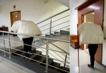 delivery man climbing stairs with heavy parcel