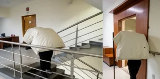 delivery man climbing stairs with heavy parcel